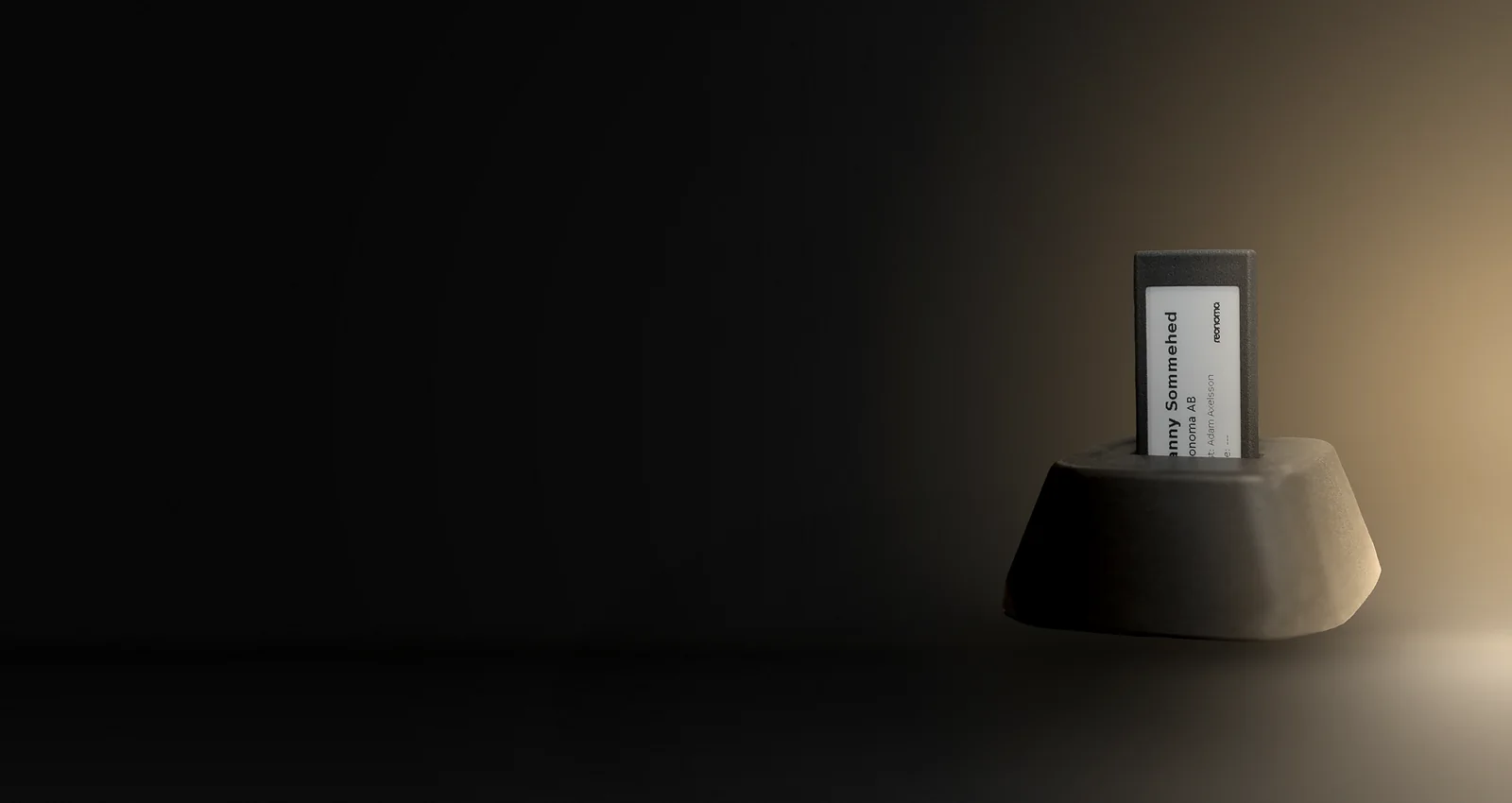 A Reonoma docking station holding an e-paper visitor badge on a reception floor